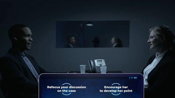 Screenshot from Devogames. A man and a woman face opposit one another in an interrogation room. Two options are presented to the viewer at the bottom of the screen.