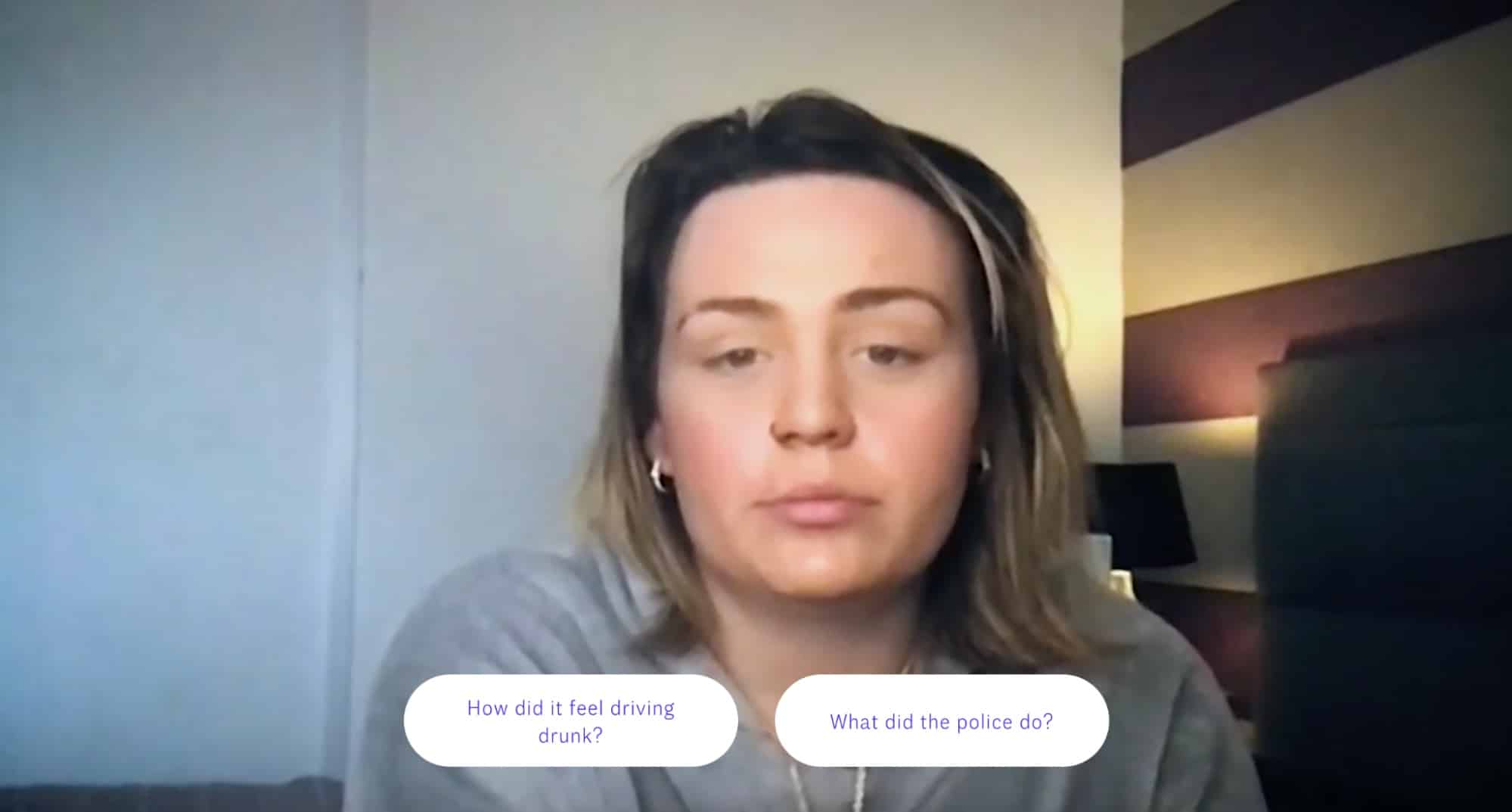 A lady on a video call awaits a question - the viewer is offered a choice of two questions at the bottom of the screen.