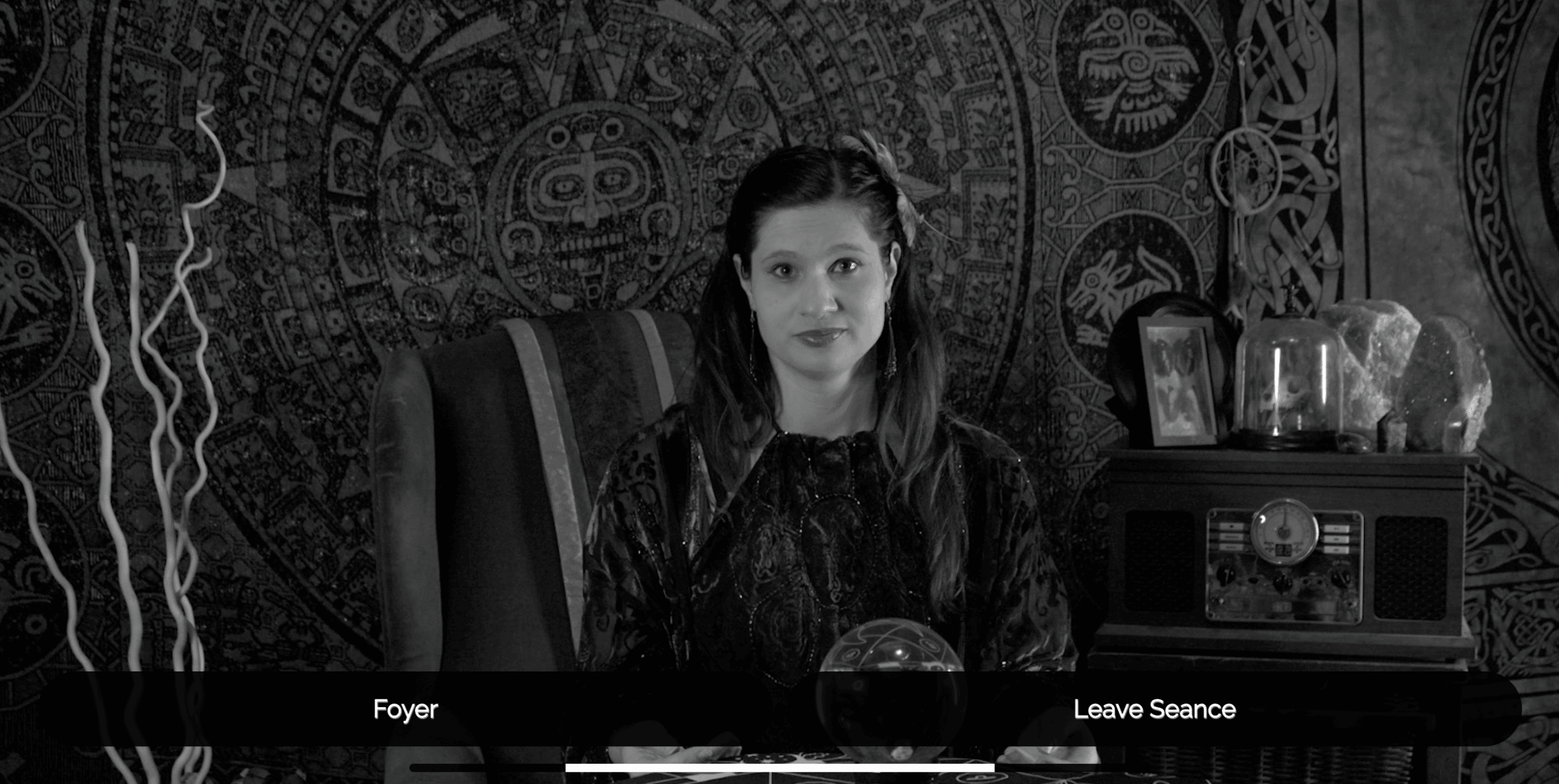 Interactive Seance - Live Action project from Austin Community College Students - A woman sits at a table staring at the camera in black and white. Choices on screen read: "Foyer", "Leave Seance"