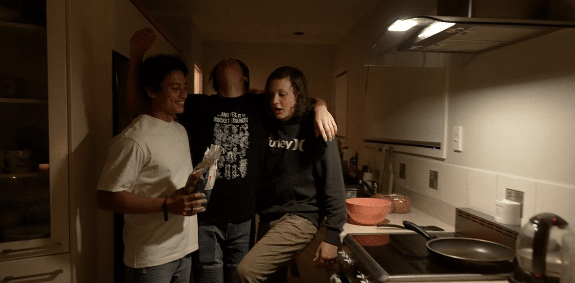 Three male young adults are drinking alcohol in a kitchen. Still image from 'The After Party' - an interactive social awareness campaign