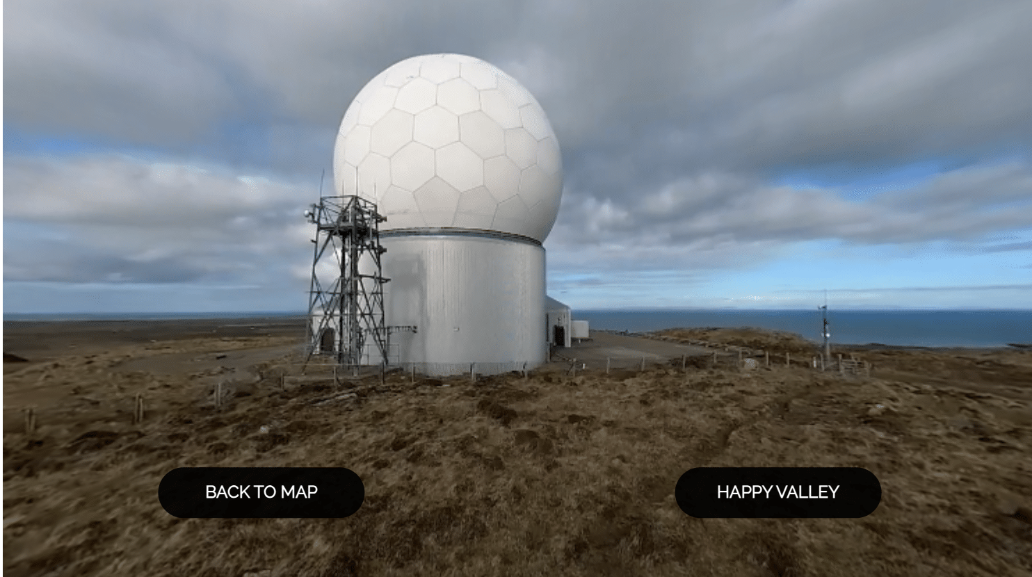 360 VR with buttons on screen - the viewers is given the option to go back to the map or move onf ton "happy valley" - on screen we see a building with a round top.