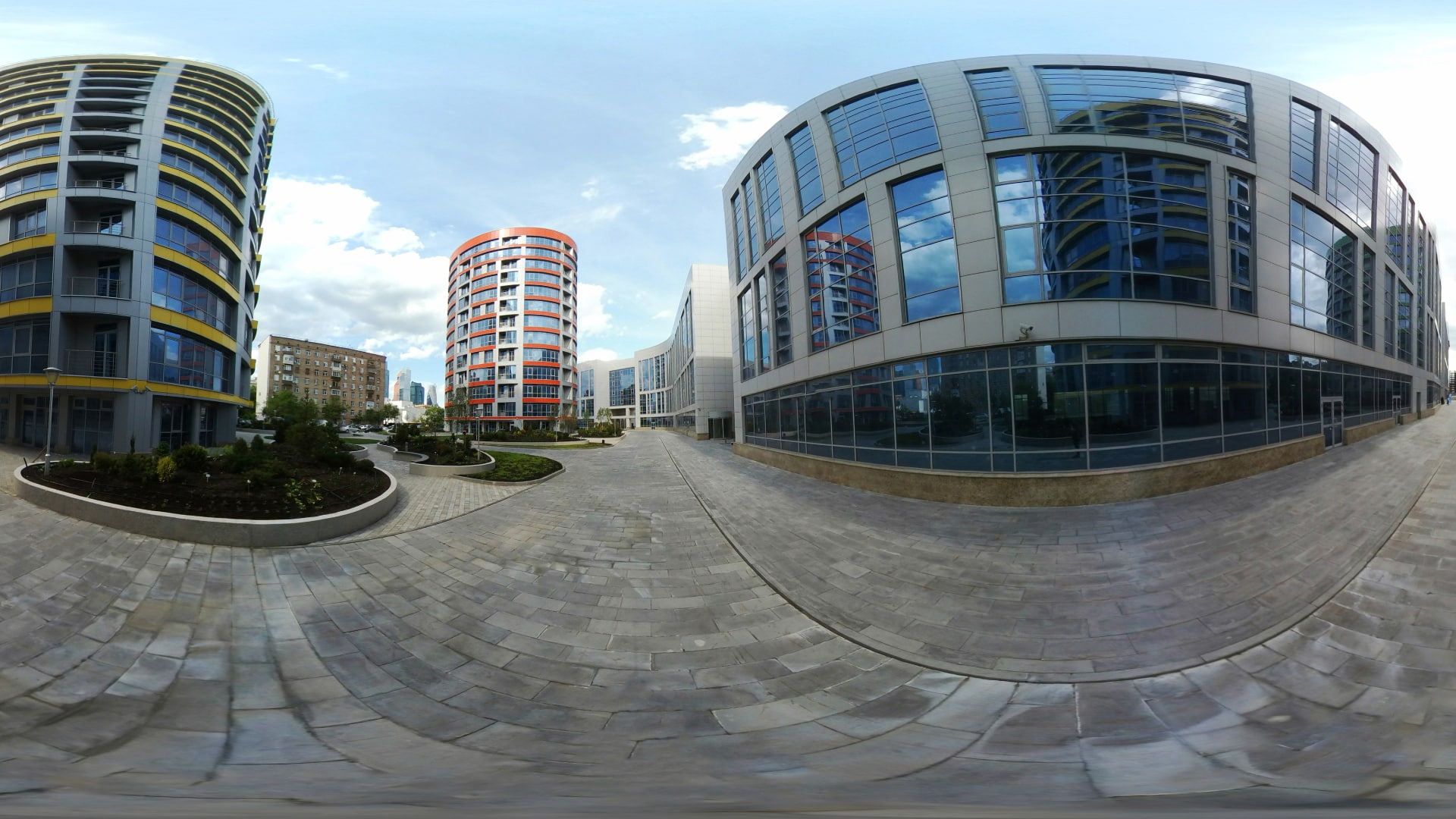 360 view of buildings - building with lots of windows are shown in a new development. The buildings warp as the viewer moves the camera to walk through the buildings.